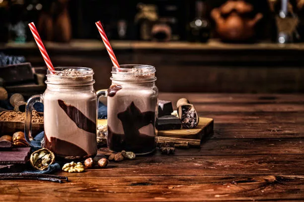 Low key chocolate smoothies on a table in a rustic kitchen